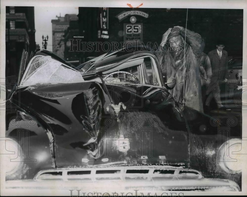 1957 Press Photo John Williams smiles besides his caved-in auto - Historic Images