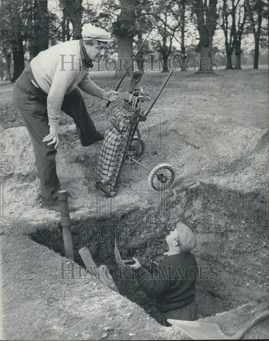 Press Photo Charlie digs for Gold balls - Historic Images