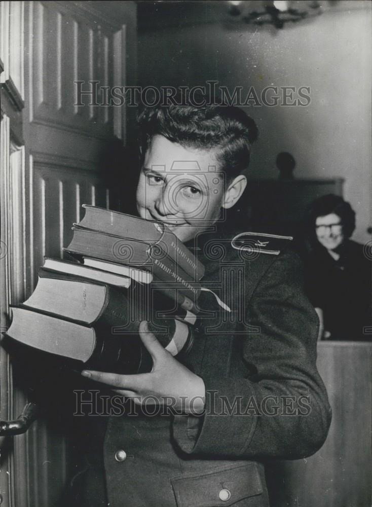 Press Photo young academy cadet leaves the library with his study books - Historic Images