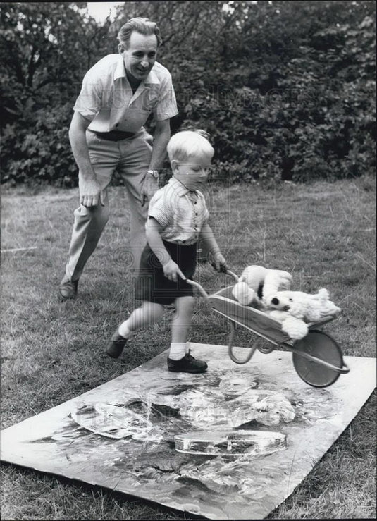Press Photo Boy Jeremy Wheeling Barrow Over Father's Painting - Historic Images