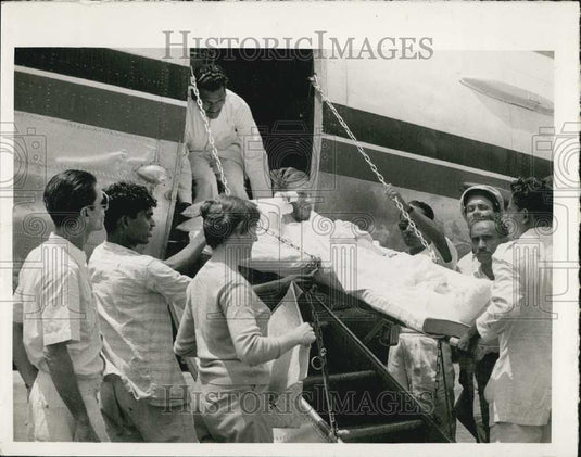1961 Press Photo Peter Mulgrew arriving on a stretcher at Dum Dum Columbia, - Historic Images