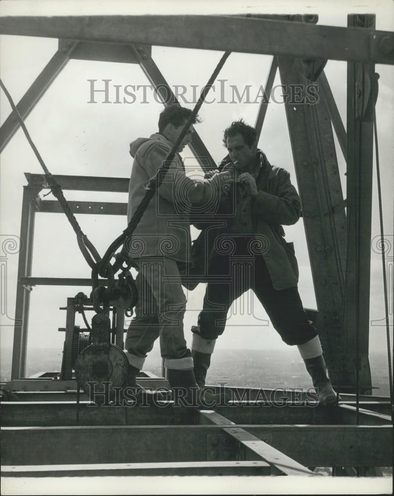 Press Photo ighting a cigarette at 400 feet tv mast Crystal palace - Historic Images