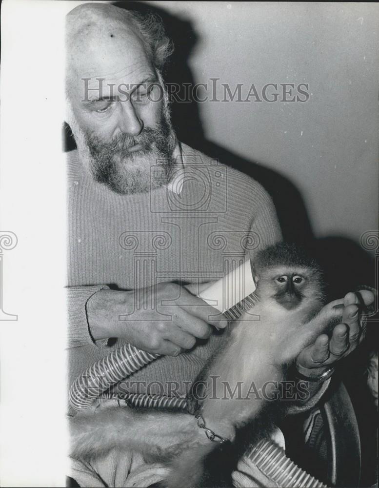 Press Photo  Mr. Bailey is seen drying the monkey&#39;s hair. - Historic Images