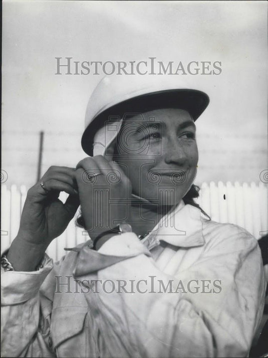 Press Photo Woman attaching her helmet - Historic Images