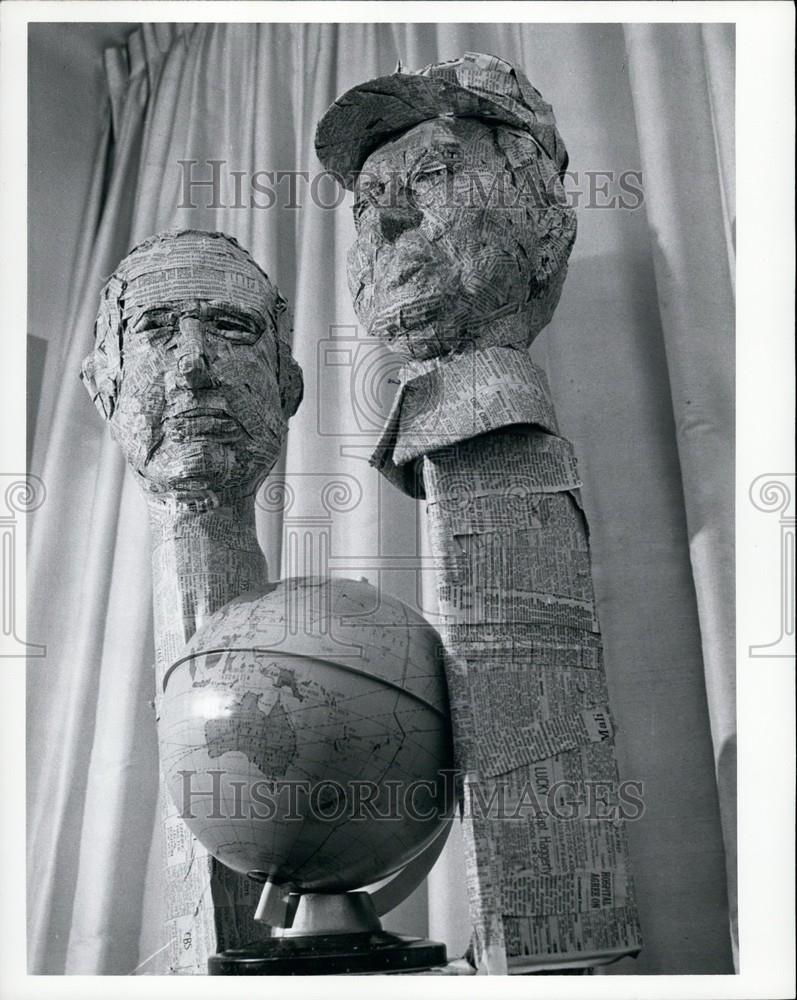 Press Photo Art Piece Globe With Two Busts Made Out Of Newspaper - Historic Images