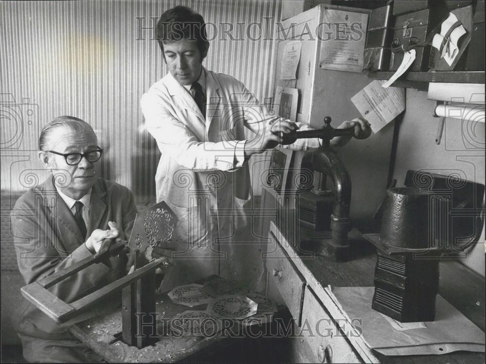 Press Photo Father and son work at fret cutting and pressing - Historic Images