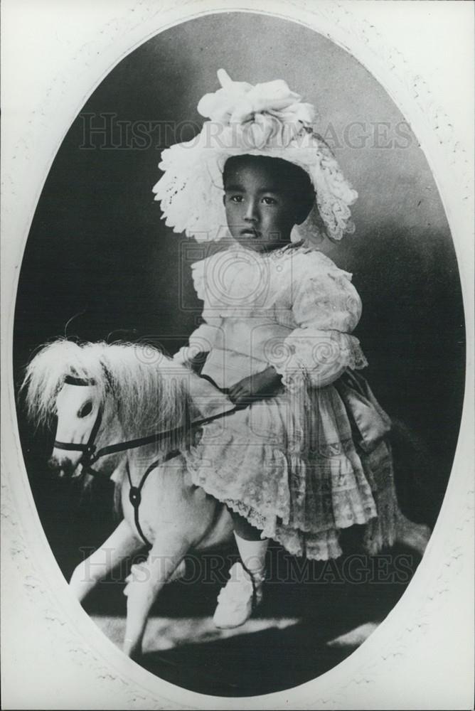 Press Photo Child Sits On Toy Horse - Historic Images