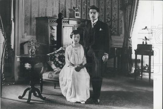 Press Photo A Young Man Next To A Seated Child, Possibly Japanese - Historic Images