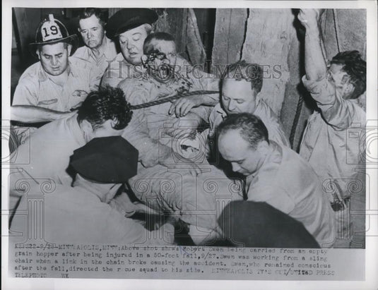 1954 Press Photo Robert Swen Carried From Grain Hopper After Falling - Historic Images