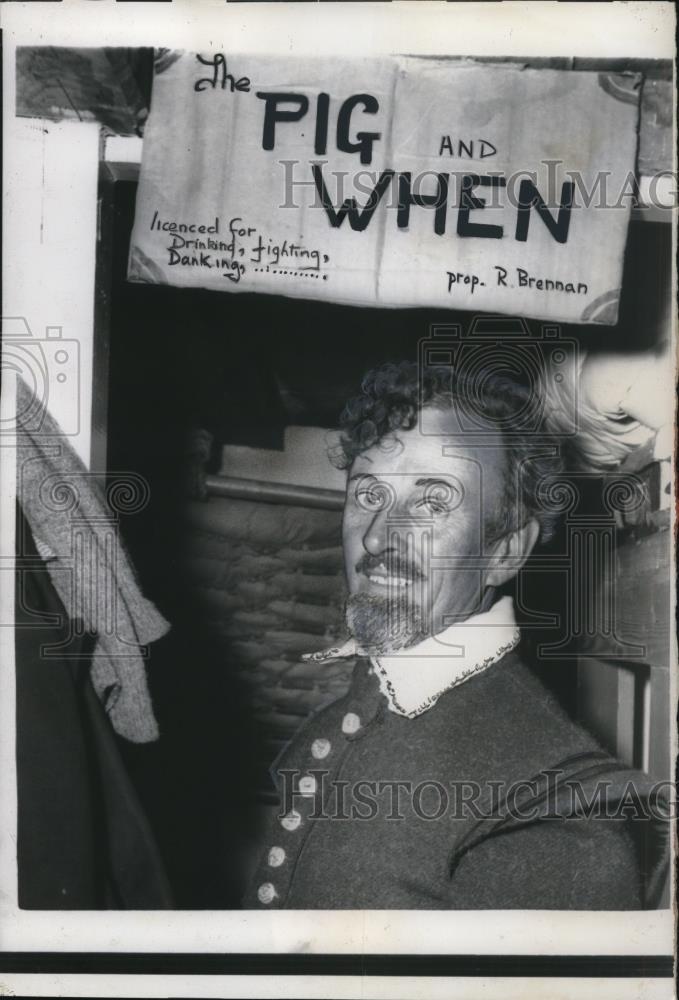 1957 Press Photo Stewart Upham proudly shows a club for crewmembers, Pig &amp; When - Historic Images