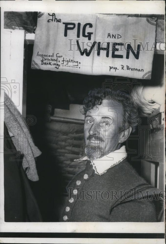 1957 Press Photo Stewart Upham proudly shows a club for crewmembers, Pig & When - Historic Images