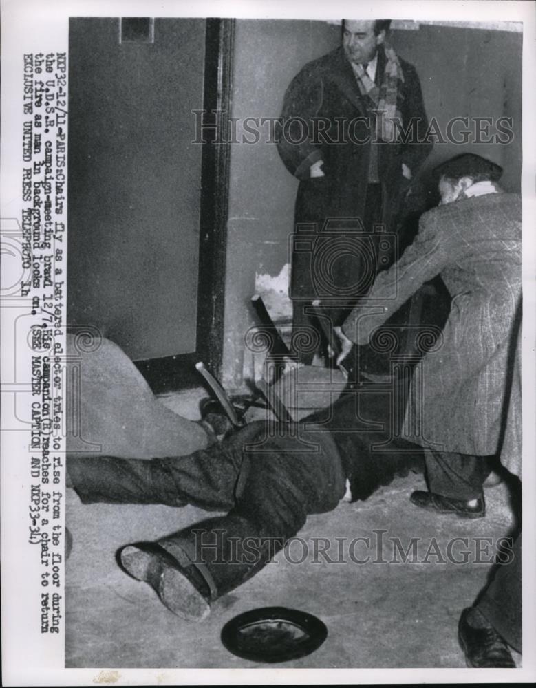 1935 Press Photo Man tries to rise from floor during the UDSR Campaing Meeting. - Historic Images