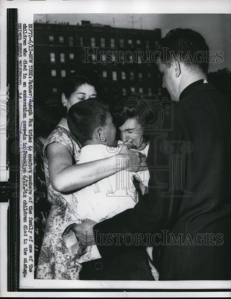 1956 Press Photo Father Joseph Fox Comforts Family of Child Died in Cave In - Historic Images