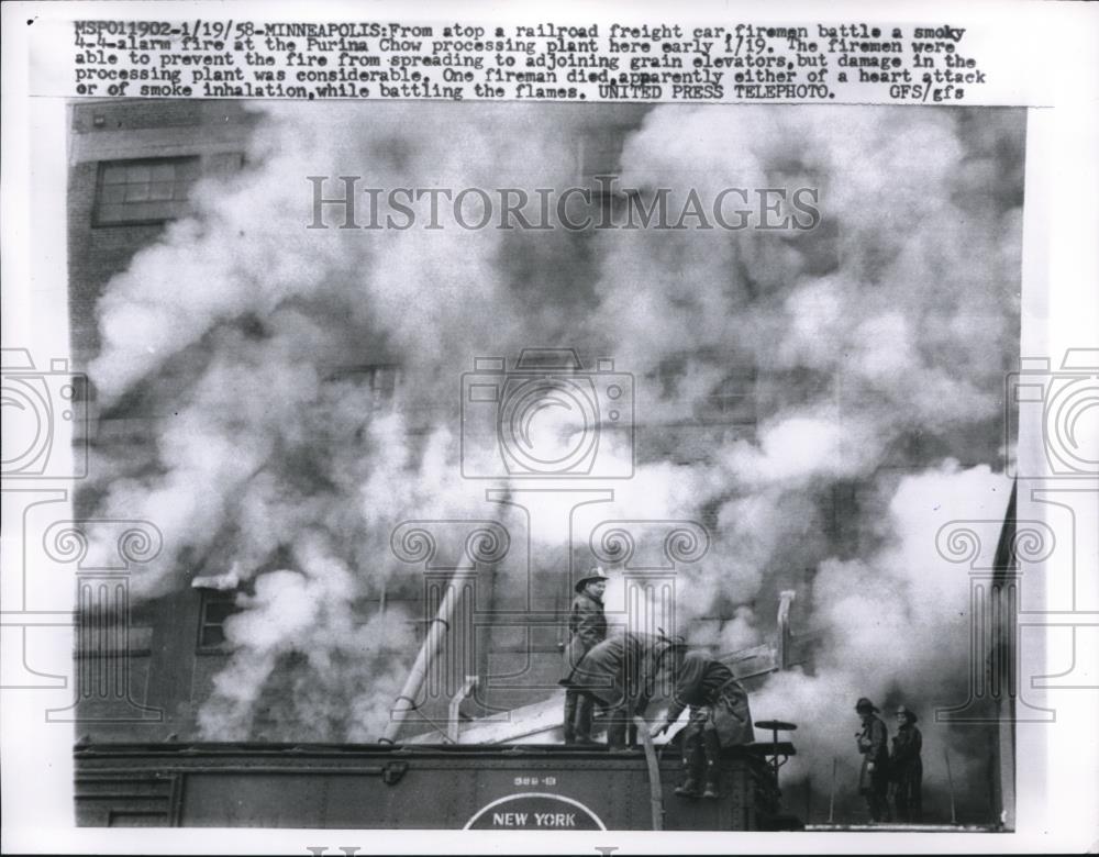 1958 Press Photo Firemen battle the smoky four alarm fire at Purina Chow plant - Historic Images