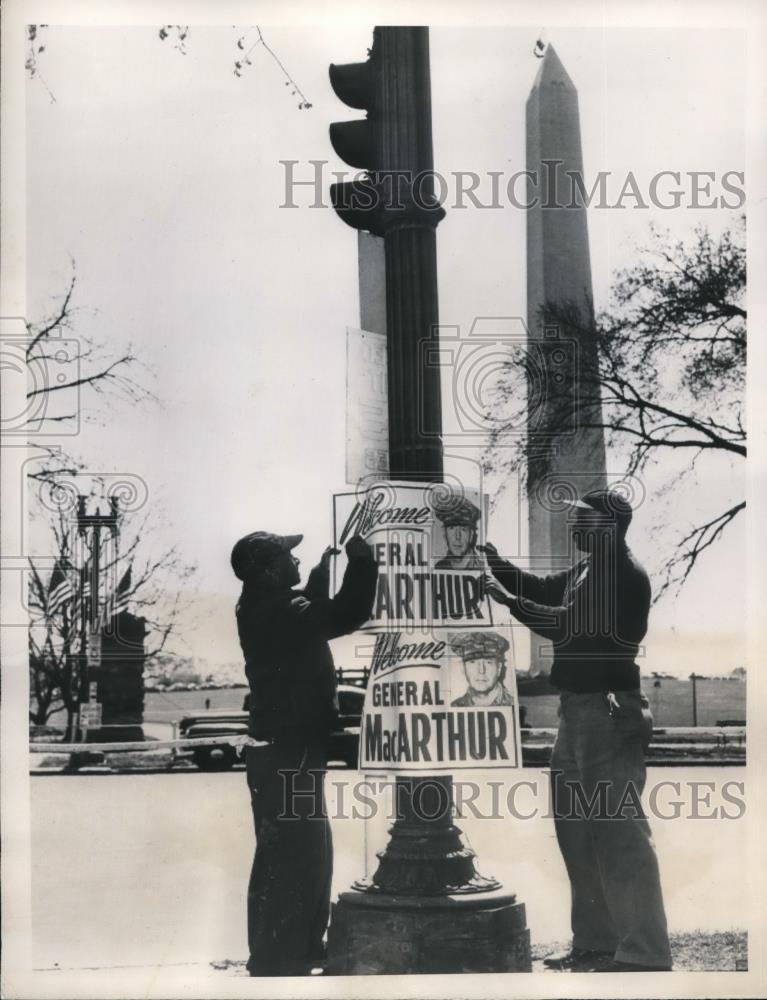 1951 Press Photo Workmen hang Welcome MacArthur signs along parade route - Historic Images