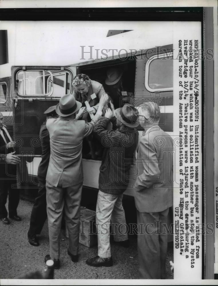 1959 Press Photo Unidentified woman passenger is aided from wrecked tour bus - Historic Images