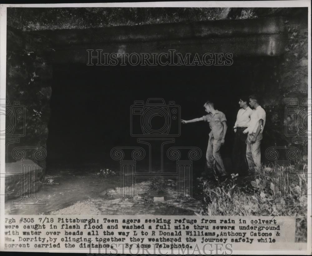 1947 Press Photo of three teenagers that were caught in a culvert during a rain - Historic Images