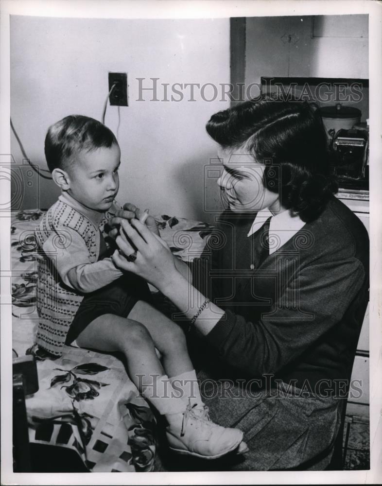 1952 Press Photo Margaret Kelleher performs baby sitting to Jimmy McGann. - Historic Images