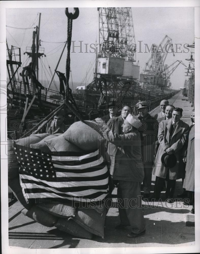 1954 Press Photo Draped with Stars and Stripes the first cluster of grain sacks - Historic Images