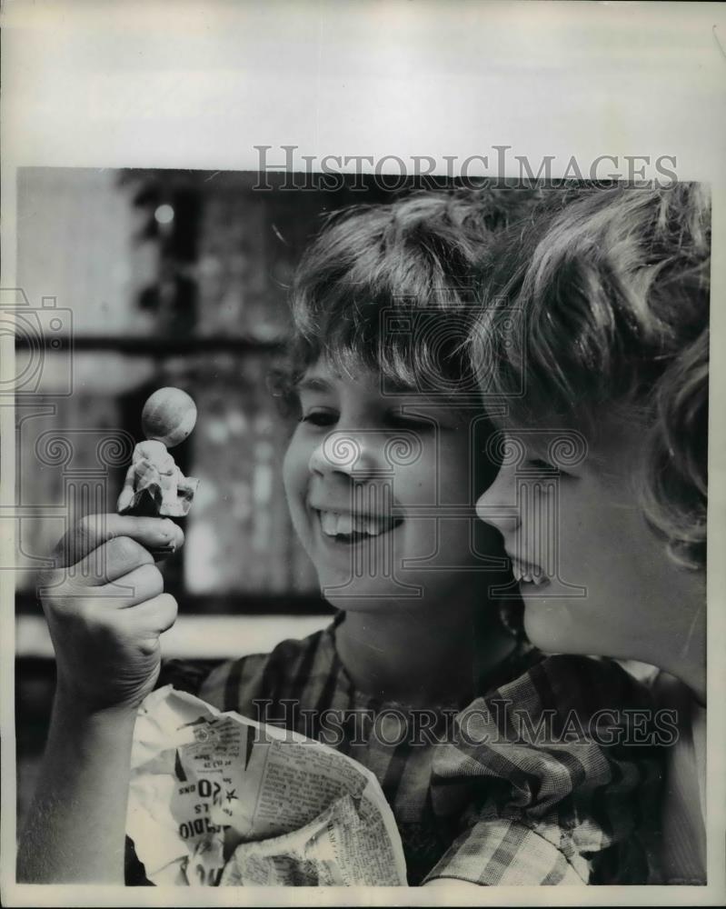 1958 Press Photo Tiny doll is a prized purchase of two young girls - Historic Images