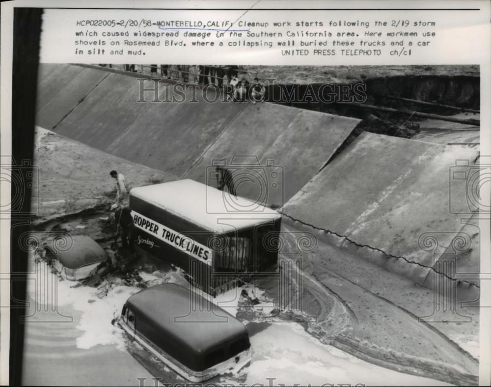 1958 Press Photo of workmen in Southern California digging out vehicles. - Historic Images