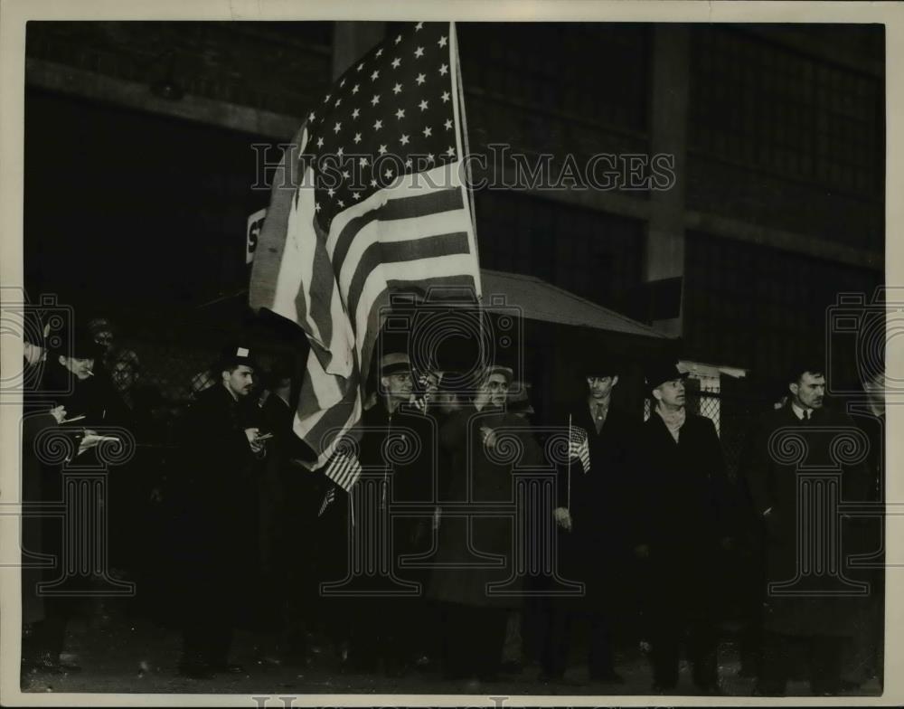 1937 Press Photo Men coming out of Fisher Olant carrying their country's flag. - Historic Images