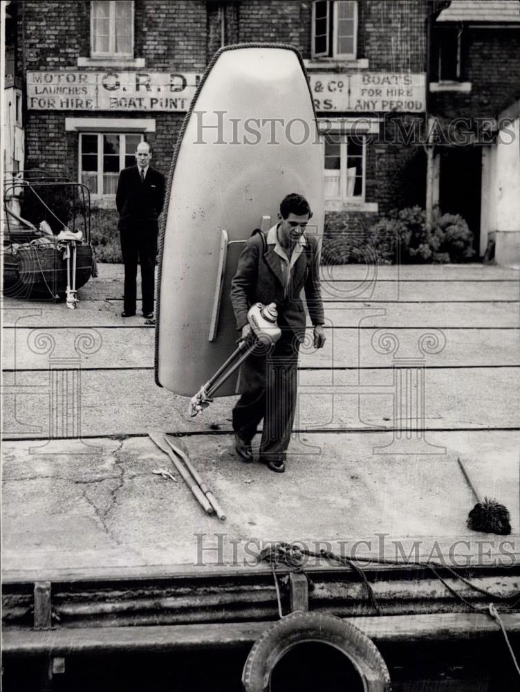 1950 Press Photo A "glass" boat so light that a man can carry it on his back - Historic Images