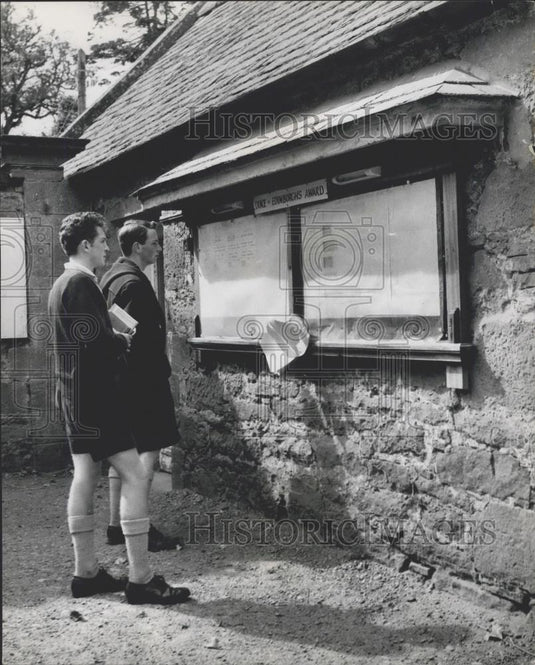 Press Photo Senior boys studying the Duke of Edinburgh's Award Notice Board - Historic Images