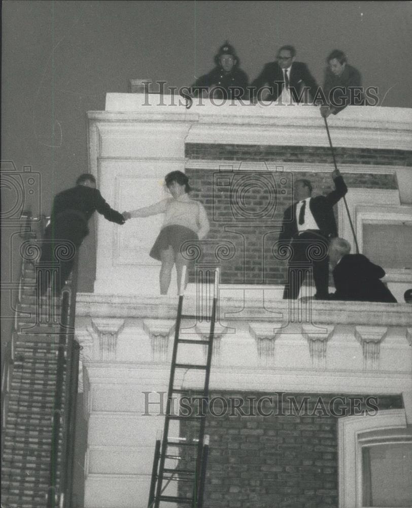 1968 Press Photo Woman on ledge 60 ft up rescued by fire dept and police - Historic Images