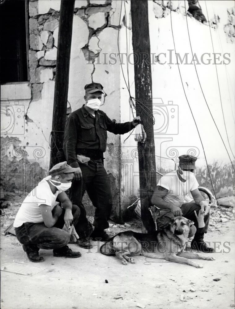 Press Photo GIs with a dog they found buried in a crevasse after earthquake - Historic Images