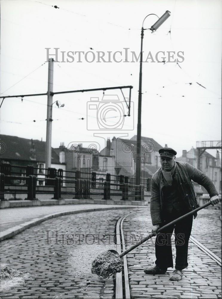 Press Photo Man shoveling dirt off of the Train tracks - Historic Images