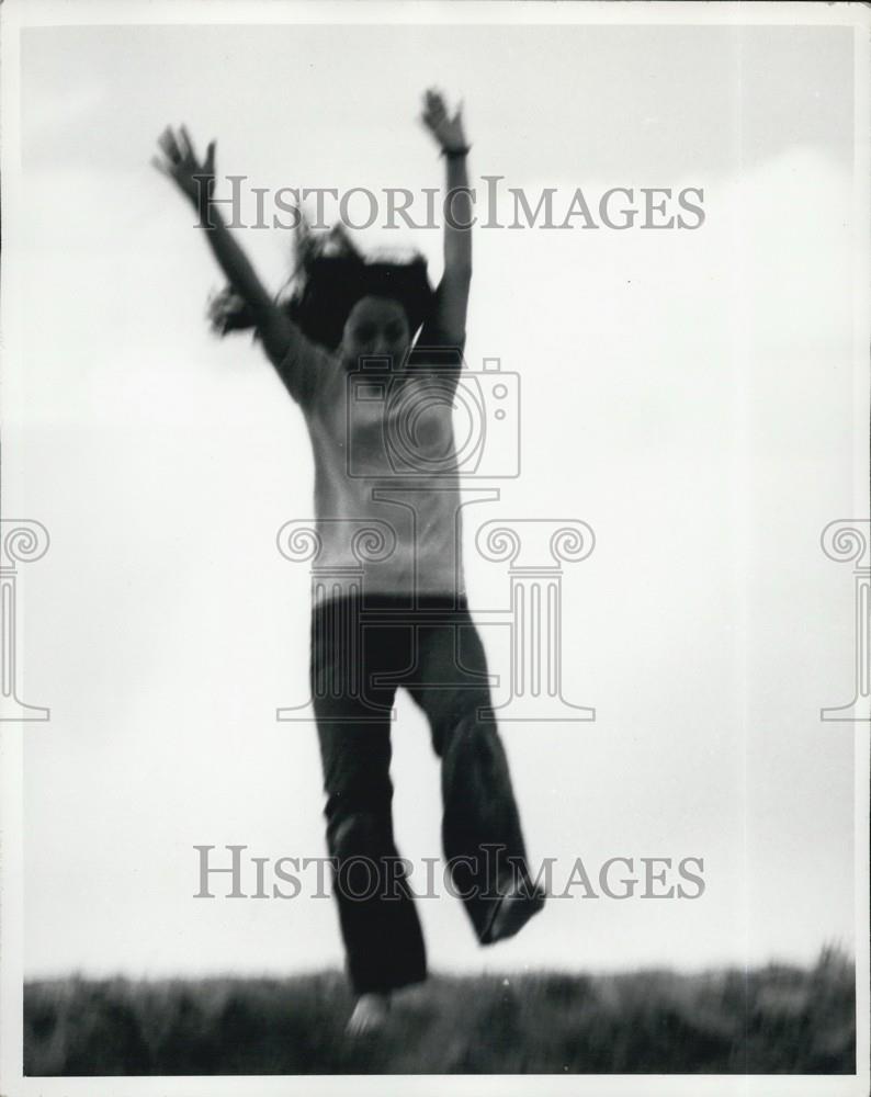 Press Photo Girl jumping in the air - Historic Images