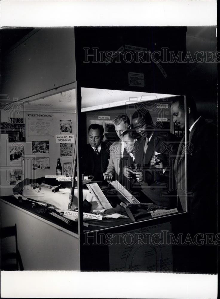 Press Photo Police examine display of weapons captured by police - Historic Images