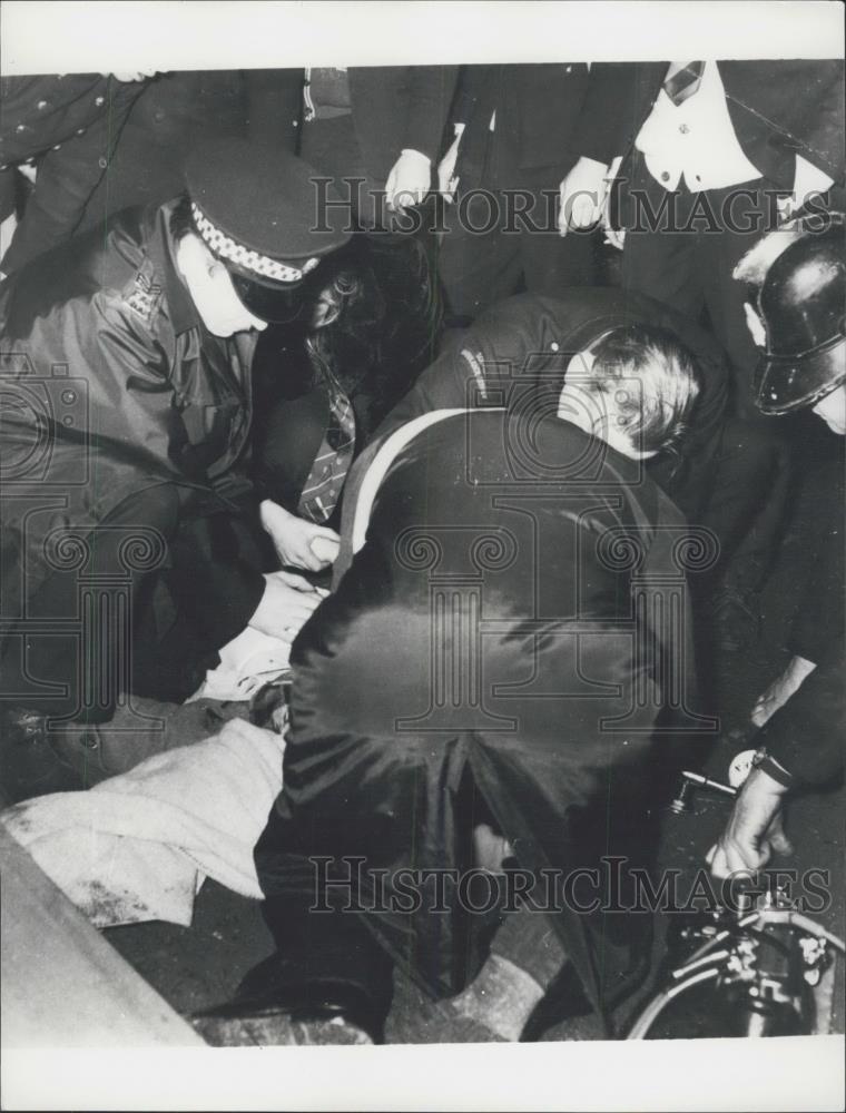 1971 Press Photo Police with a trample victim at football game - Historic Images