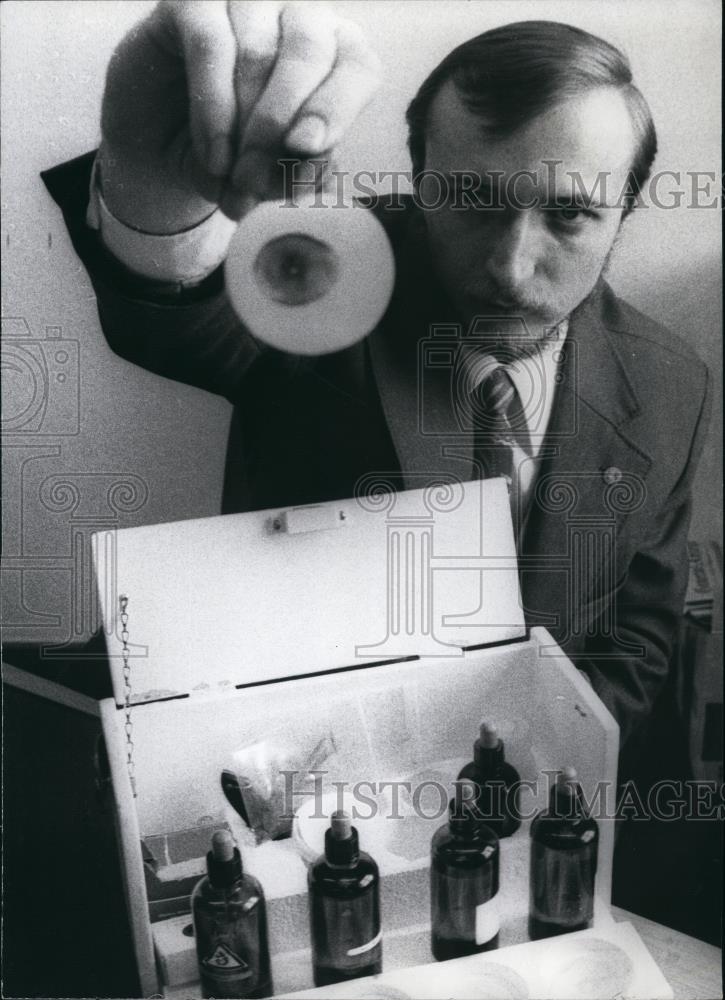 Press Photo Man Holds Up Object - Historic Images