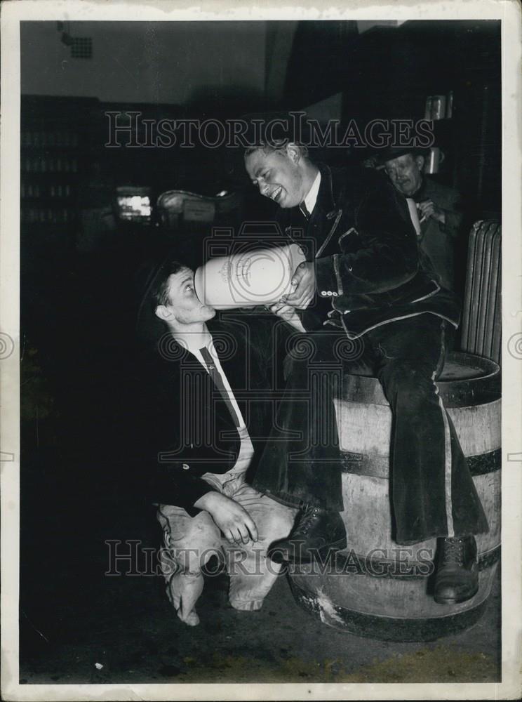 Press Photo young boys drinking out a large white bucket and smiling - Historic Images