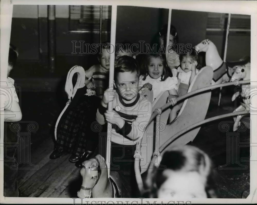 1951 Press Photo Children ride Merry-go-Round in May&#39;s playroom - Historic Images