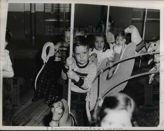 1951 Press Photo Children ride Merry-go-Round in May's playroom - Historic Images