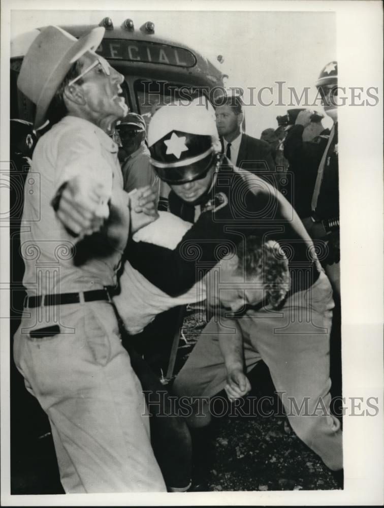 1964 Press Photo A striking copper worker is pushed down by a police officer - Historic Images