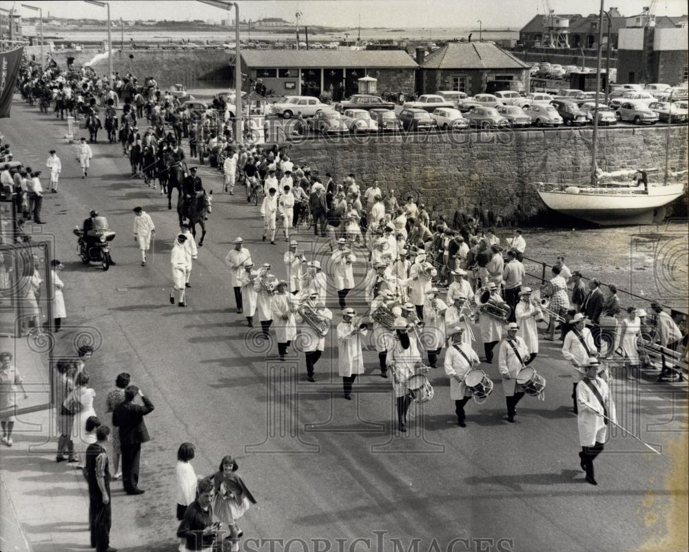 Press Photo procession moves along St. Peter&#39;s Port harbour front - Historic Images