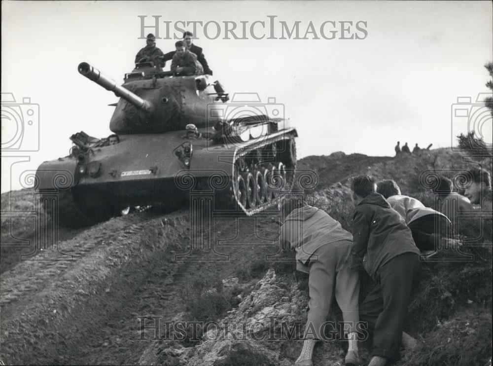 Press Photo Youths Watch Military Tank Rolling Down Hill - Historic Images