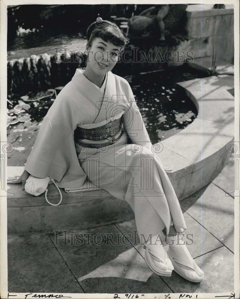 Press Photo Young Japanese Girl Sitting on a Fountain - Historic Images