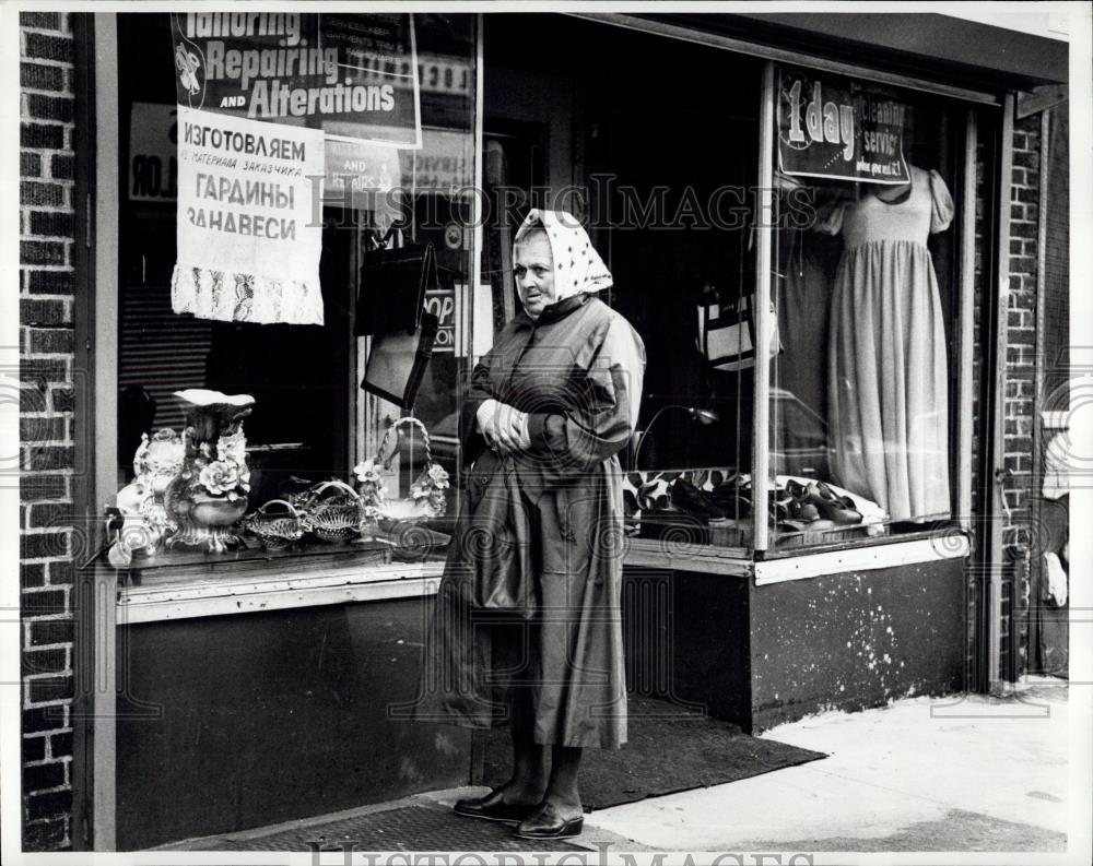 Press Photo Woman standing outside Russian store front - Historic Images