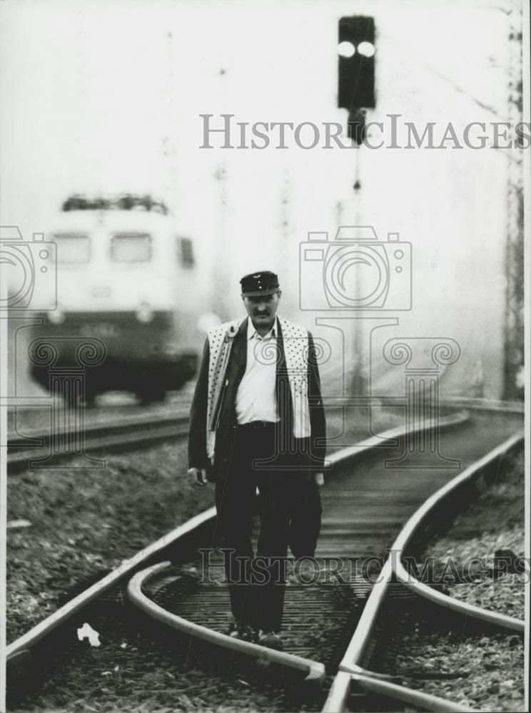 Press Photo Trackman Max Bittner walking the train yard - Historic Images