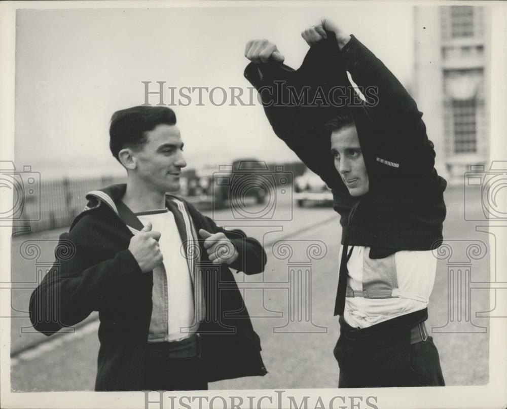 Press Photo Peter Hagel Seen Peeling Off the New Royal Navy Zip Style Jumper - Historic Images