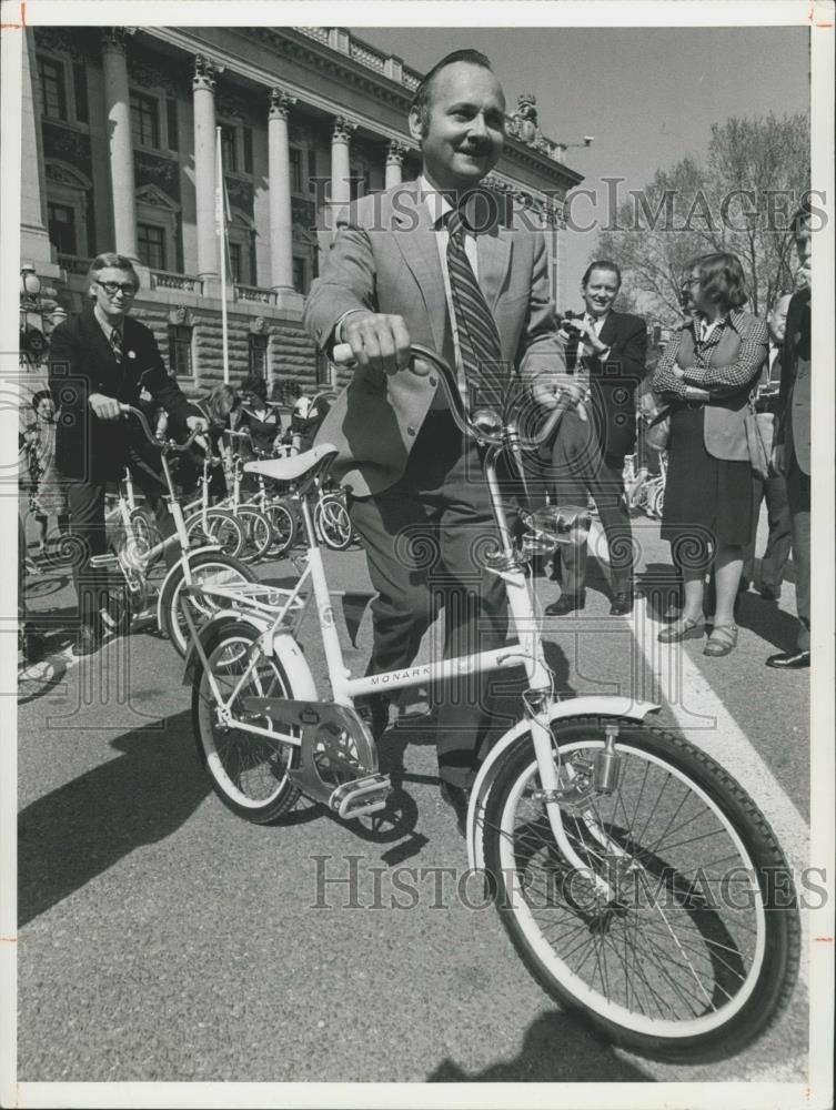 Press Photo Maurice F. Strong taking a bicycle ride. - Historic Images