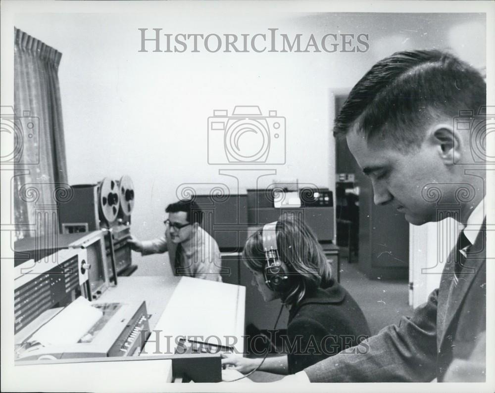 Press Photo Workers working on a machine - Historic Images