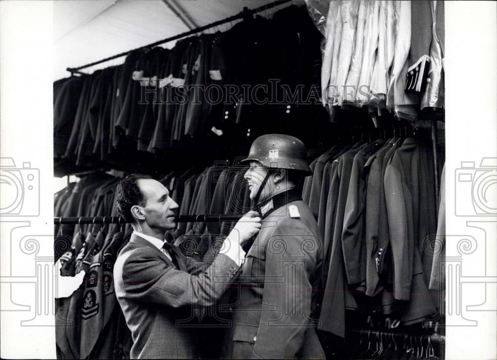 Press Photo Henry Chester fits a German wartime uniform on a member of the staff - Historic Images