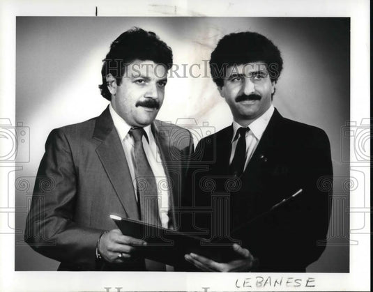 1986 Press Photo Joseph Mogab standing with Fares J Francis - Historic Images