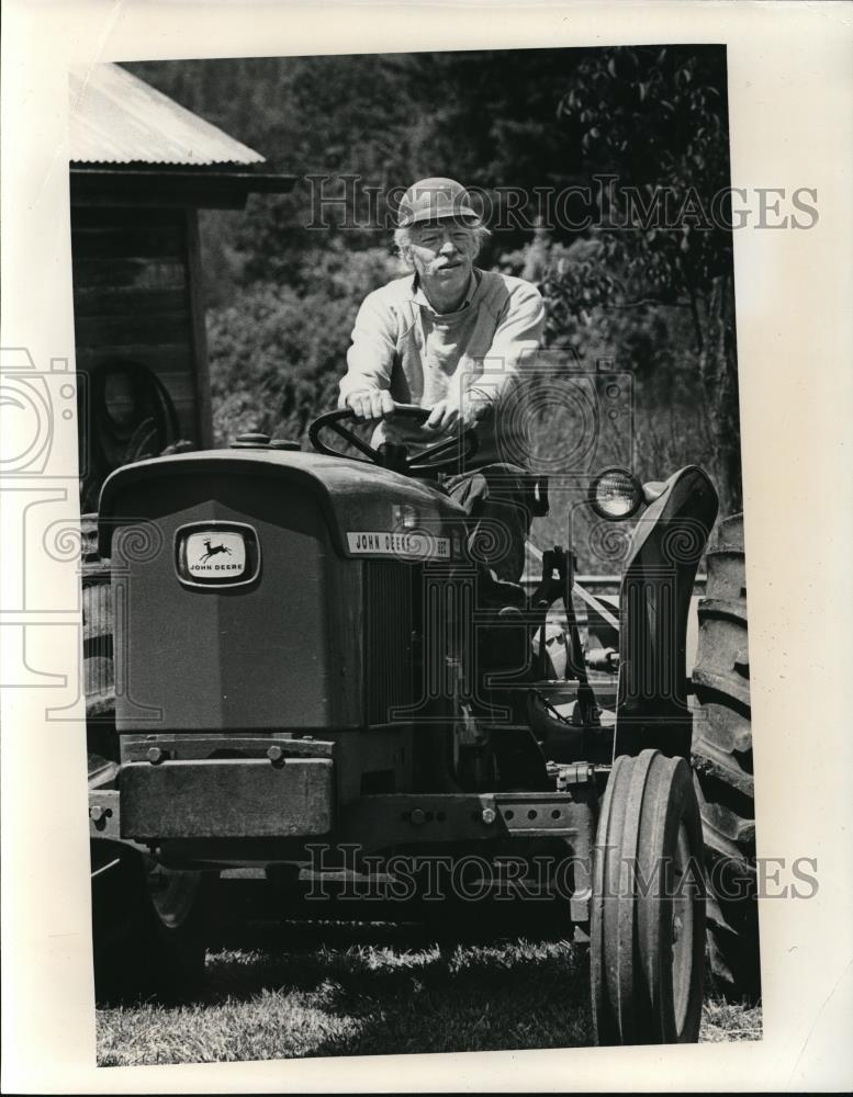 1976 Press Photo Farmer Harold Hughes aboard his tractor, to toil land - Historic Images